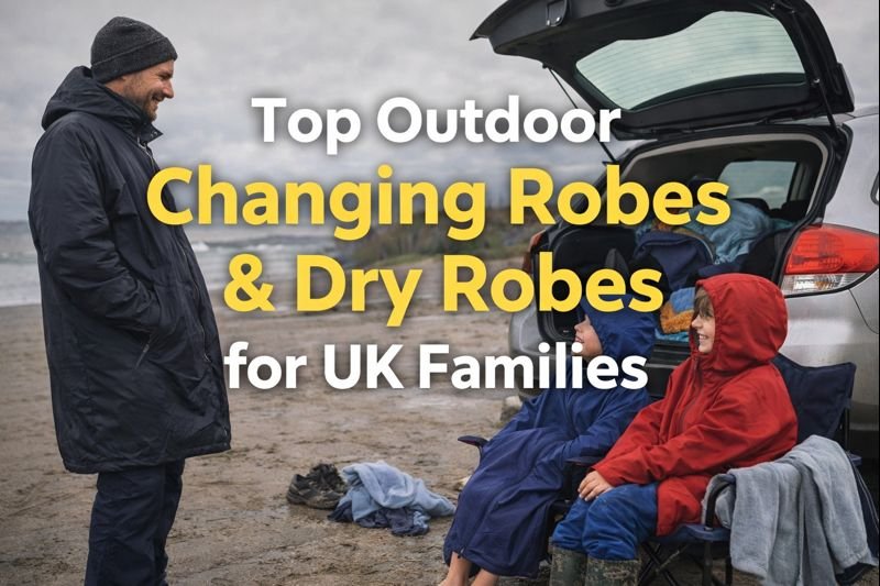 Children wearing outdoor changing robes beside a car on a UK beach after a cold, wet day