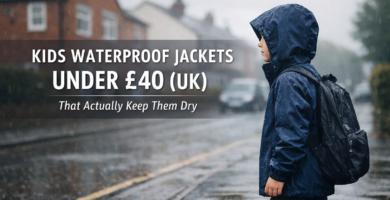 Child wearing a navy waterproof jacket in UK rain during school run, featured image for kids waterproof jackets under £40 guide.