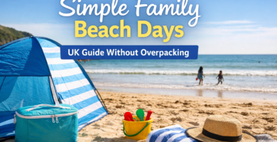 Family beach setup in the UK with pop-up shelter, cooler bag and children playing by the sea on a sunny day