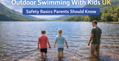 Parent supervising two children wading into a calm UK lake during outdoor swimming on a summer day