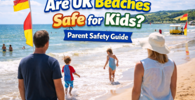 Parents watching children playing safely near the shoreline on a UK beach with lifeguard flags