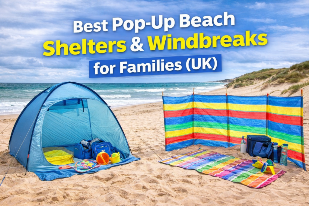 Pop-up beach shelter and colourful windbreak set up on a UK beach with towels and bags for a family beach day guide