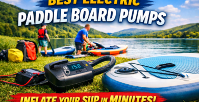 Electric paddle board pump inflating a SUP beside a UK lake before a paddle boarding trip.