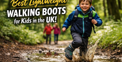Child running along a muddy woodland trail wearing lightweight walking boots during a family hike in the UK